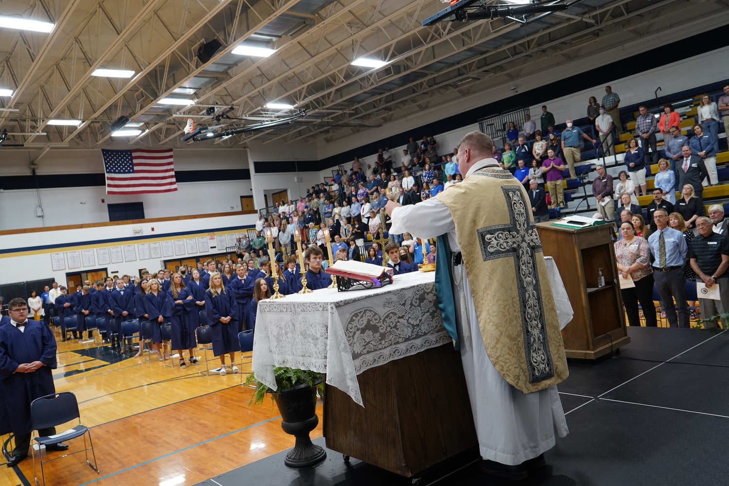 Father Stephen Jones elevates the Most Blessed Sacrament during Helias Catholic High School's 2021 Baccalaureate Mass in the Jim Rackers Fieldhouse.